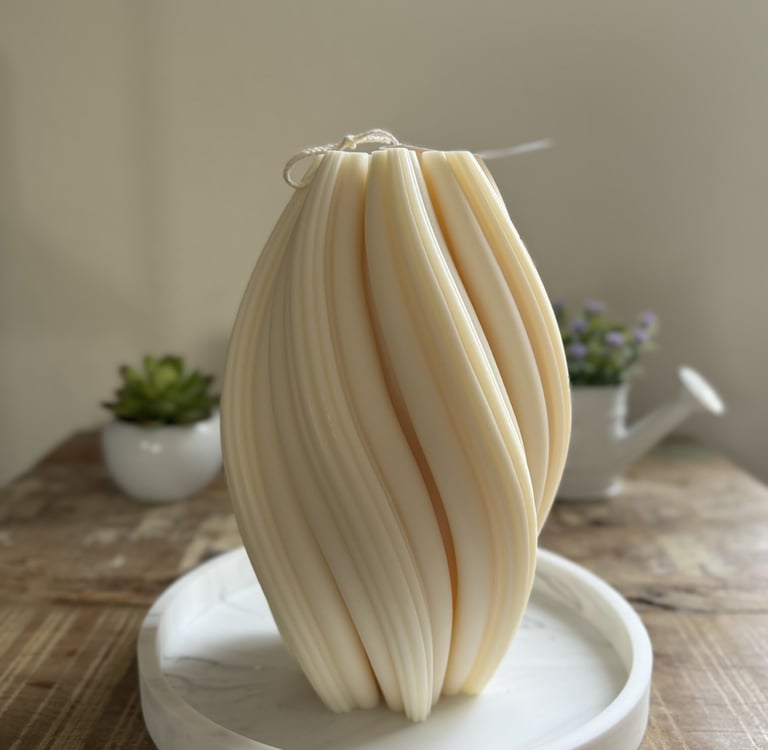 White twisted candle over a plate