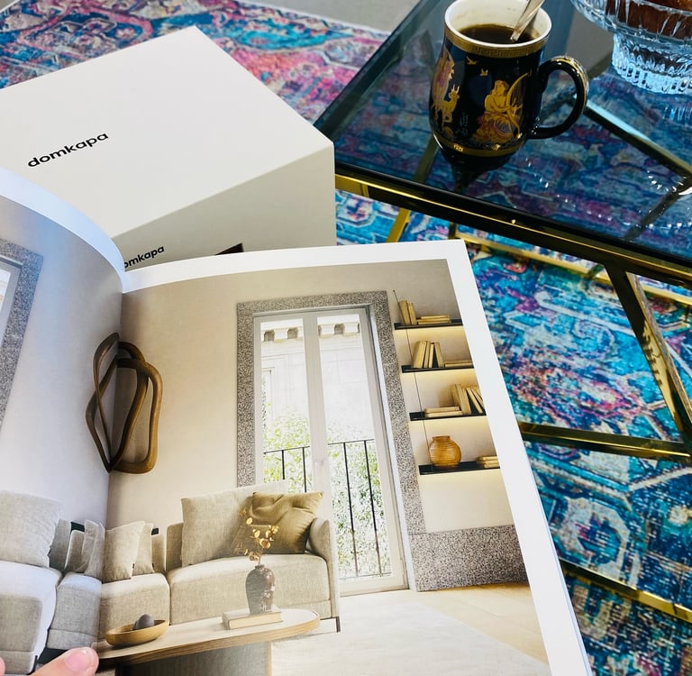 a person holding a book with a coffee cup