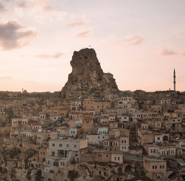 Sunset over Uçhisar Castle and stone village in Cappadocia, Turkey