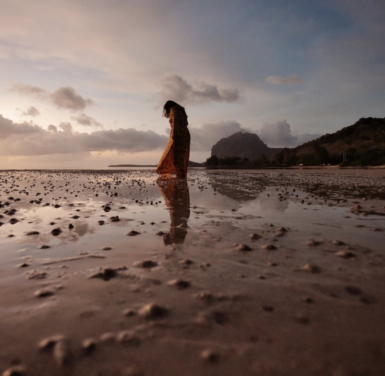 Silhouette of a woman on the beach with Le Morne Brabant in the background, Mauritius