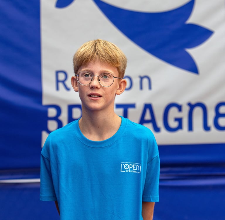 a young boy in a blue shirt and glasses