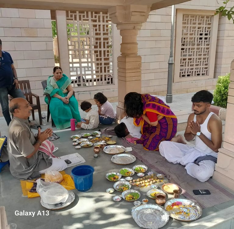 Three-generation Hindu family completing Matrugaya Pooja together at sacred Bindu Sarovar Siddhpur Gujarat