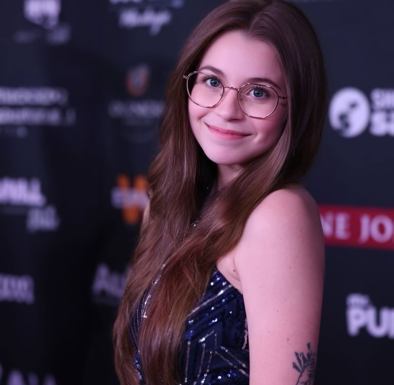 a woman with glasses and a tattoo on her arm
