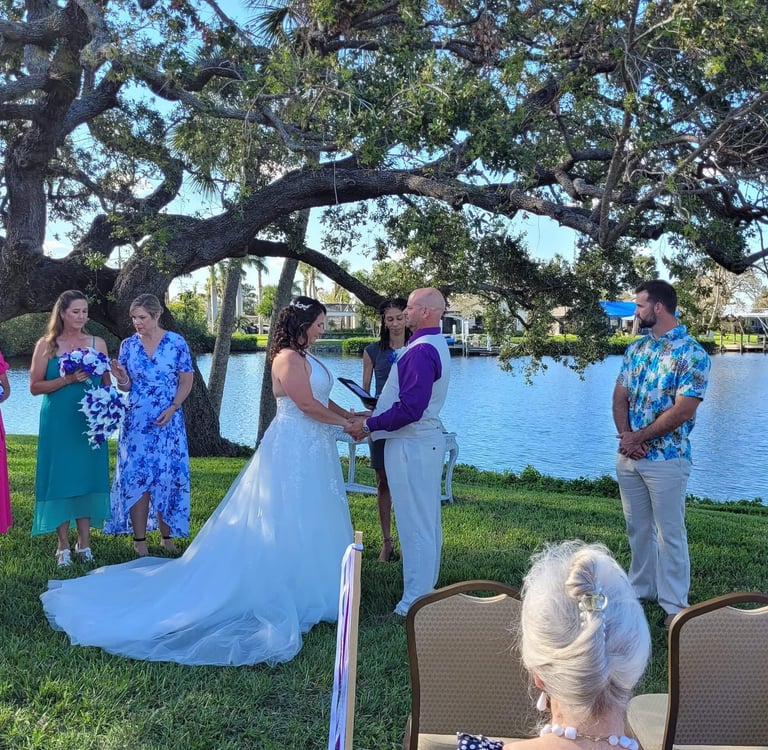 a wedding ceremony in a park with a bride and groom