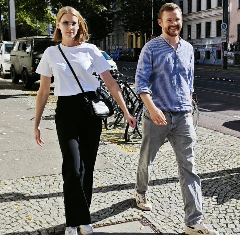 a man and woman walking down a sidewalk
