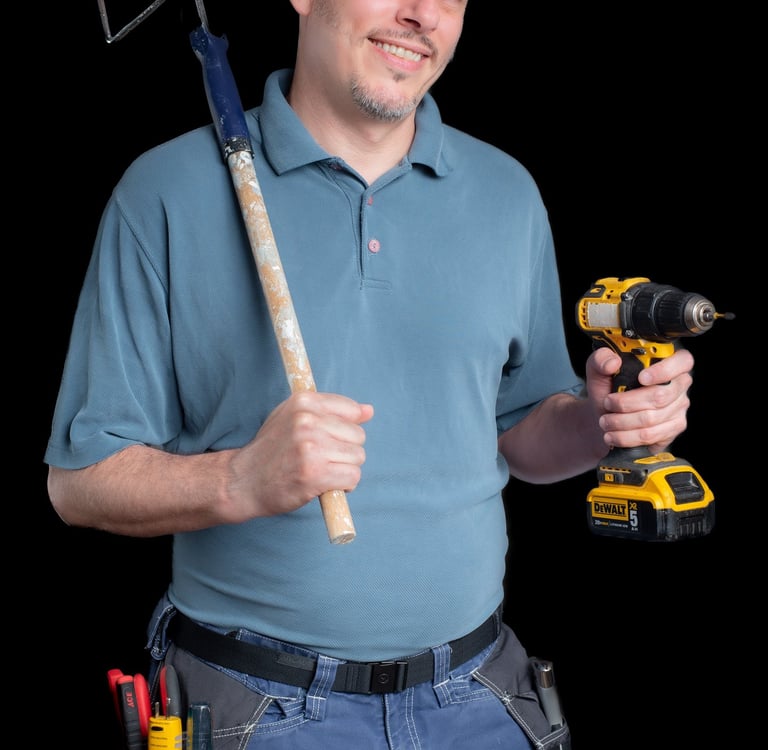 Portrait of Cyd holding a paint roller and a drill