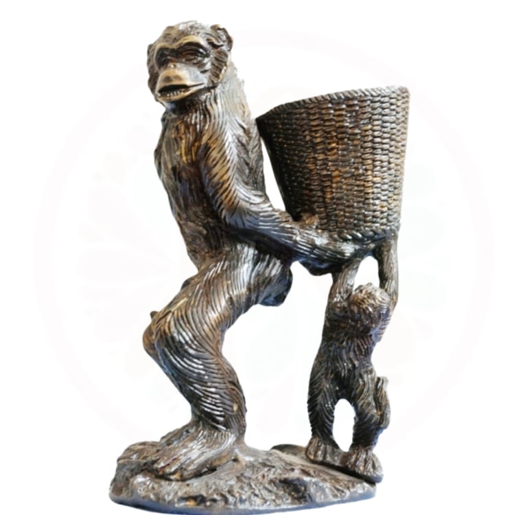 a statue of a monkey holding a basket with a basket