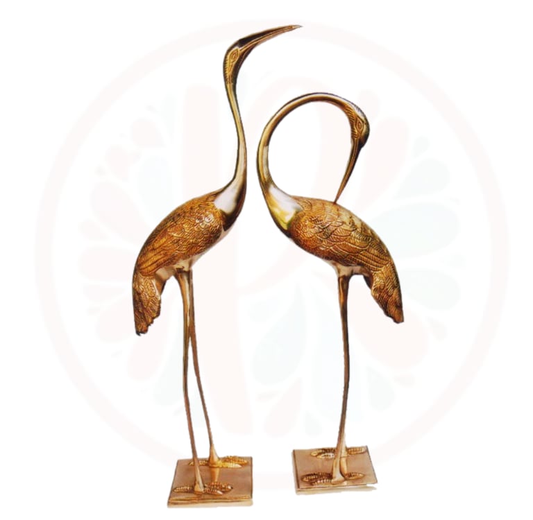 two large bronze colored birds on a stand