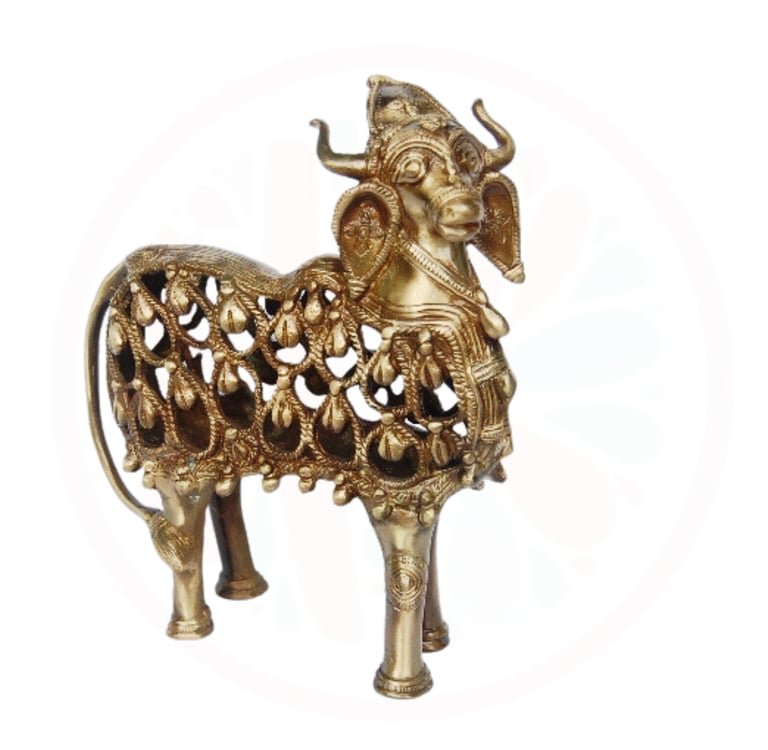a gold colored metal animal statue of a goat