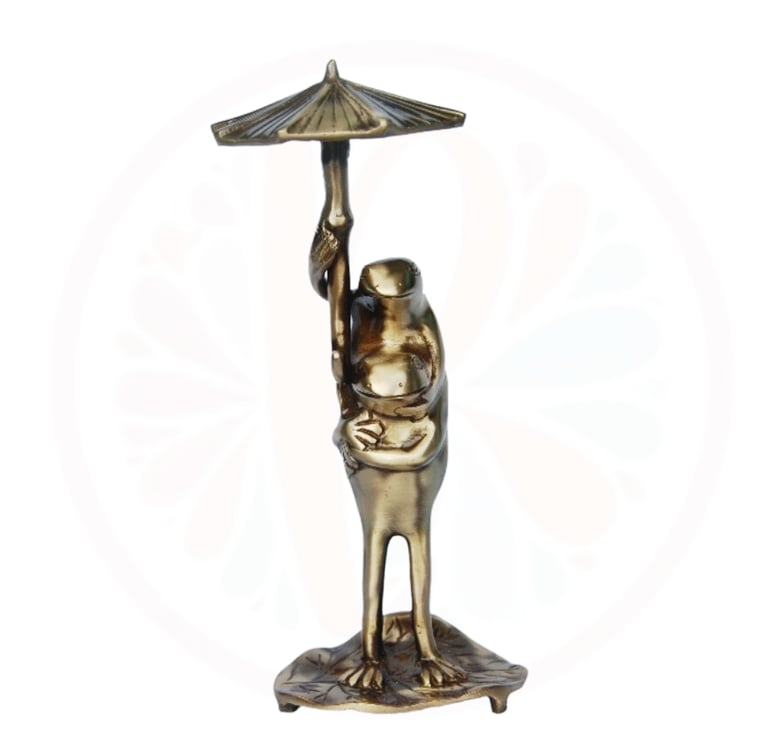 brass frog under a umbrella