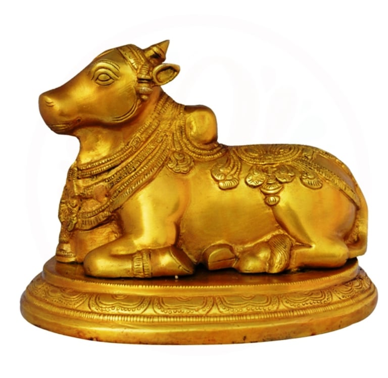 a golden cow statue of a cow in a golden color