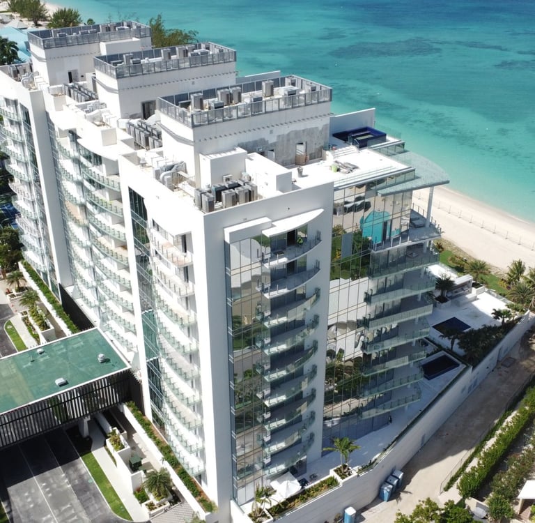 Luxury residential high-rise—The Watermark, Cayman, viewed from the beach with modern architect