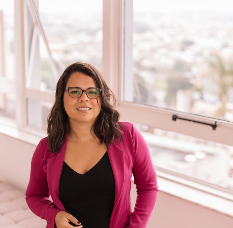 a woman therapist in her office in front of a window