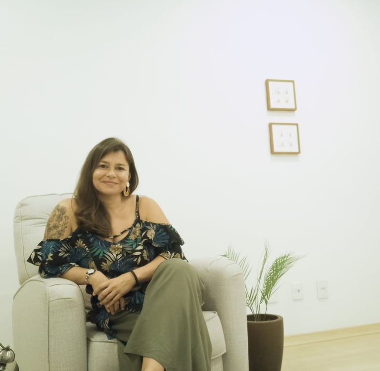 a woman therapist sitting on a couch in a therapy room