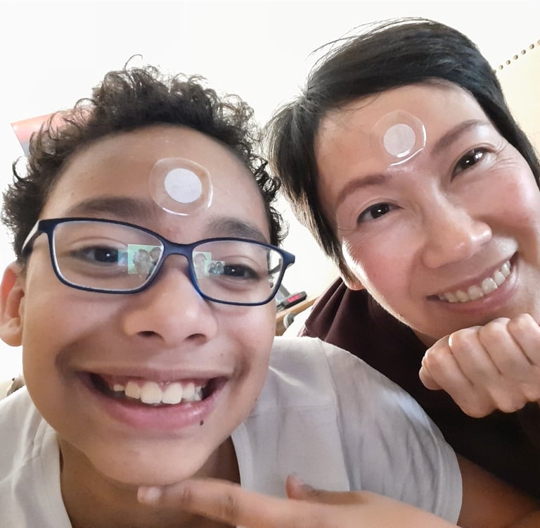 Denise and son with patches on face