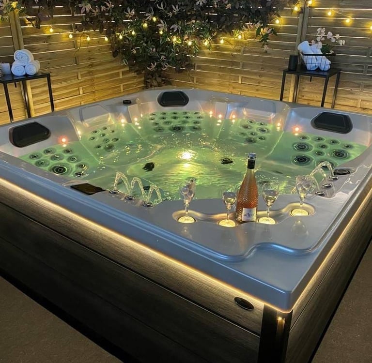 a hot tub with candles and candles on a patio