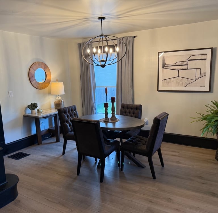 Ohio staged Modern dining room featuring a round wooden table, and a metal orb chandelier.