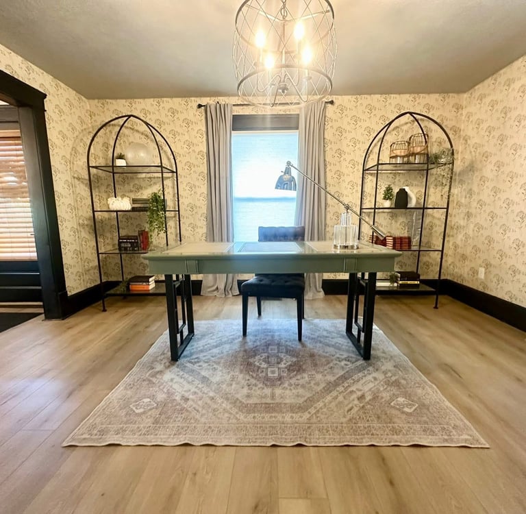 Ohio staged Modern home office with a vintage rug, floral wallpaper, and metal arched bookshelves.
