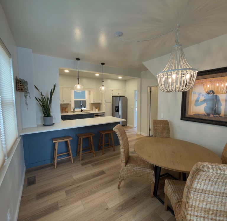 Staged Modern open concept kitchen and dining room featuring a blue breakfast bar in Ohio.