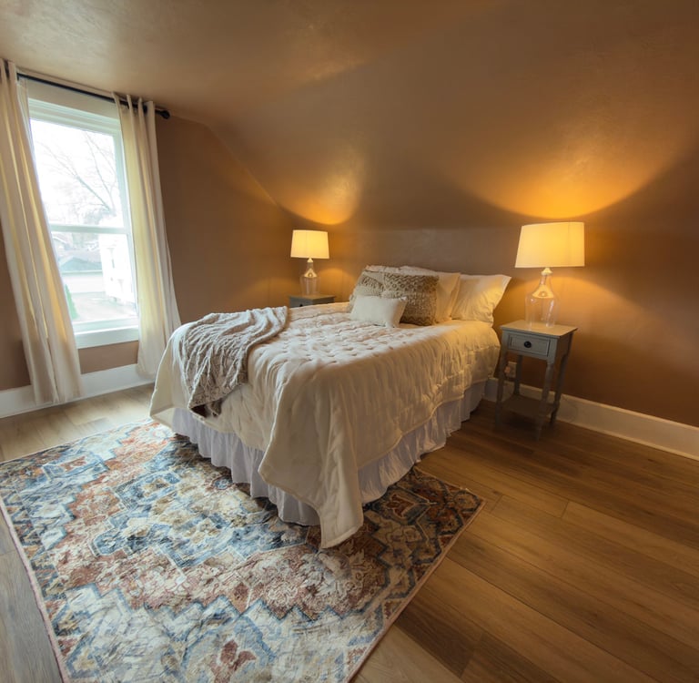 staged Cozy bedroom with warm lighting, patterned rug in Ohio.