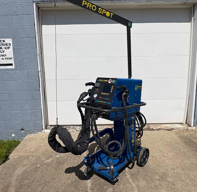 Professional Pro Spot blue mobile spot welder for automotive body repair parked outside a garage.