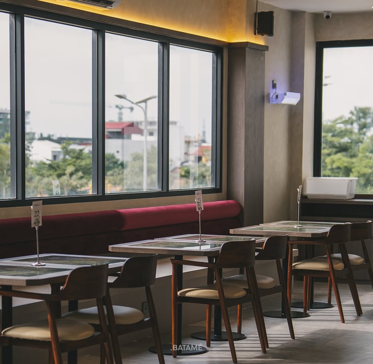 A Modern seating area with sunlight at Ornella Cafe Batam