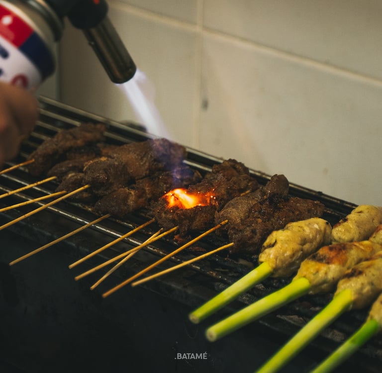 Pork Satay being torched on the griller at NUUD Batam