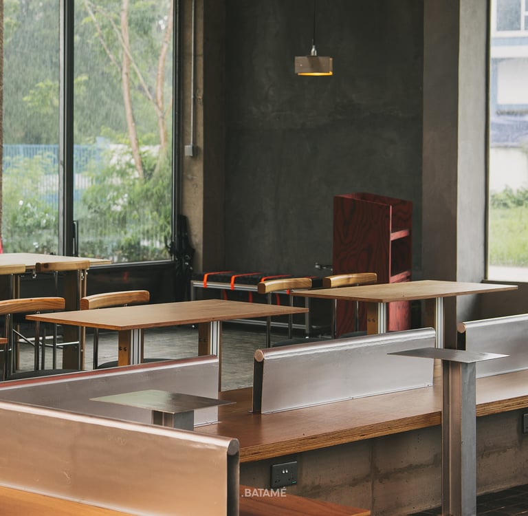 spacious wooden seating area under brutalist interior at odd Batam