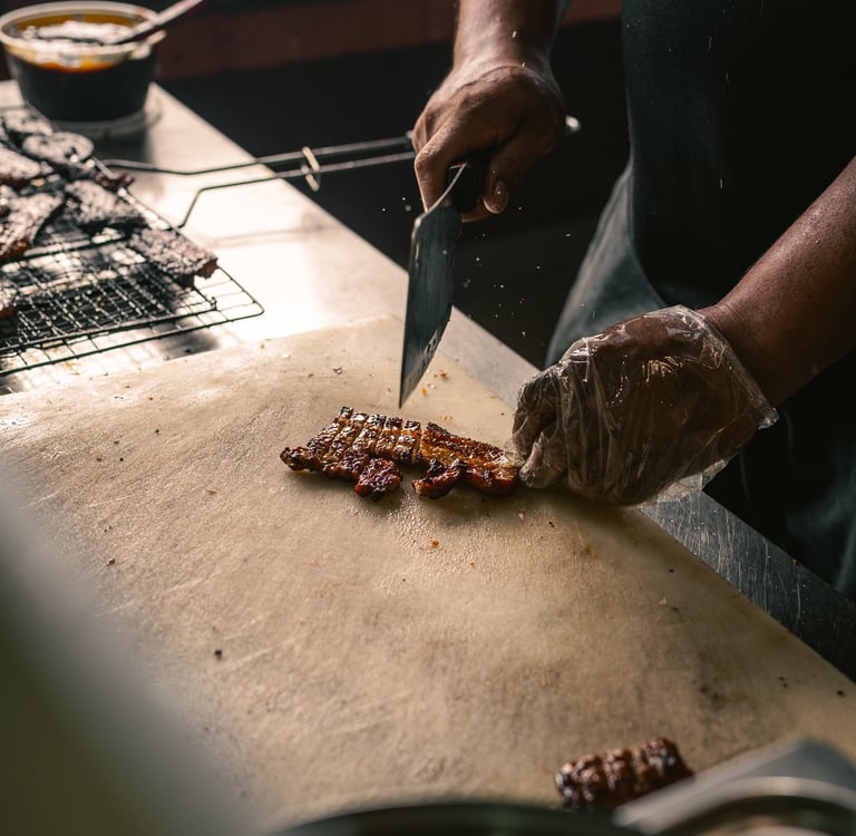 chef chopping grilled pork at BPK Chika Batam