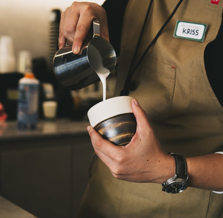 Barista pouring milk at Grind Now Coffee Bar Batam