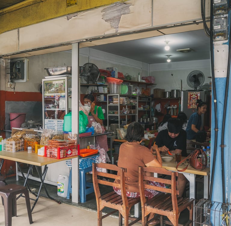 Local stall with people having breakfast at Mie Pok Ahan Mitra Batam