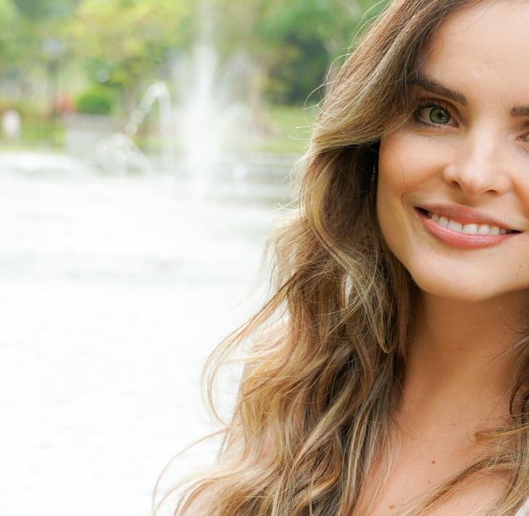 a woman with long hair and a white top