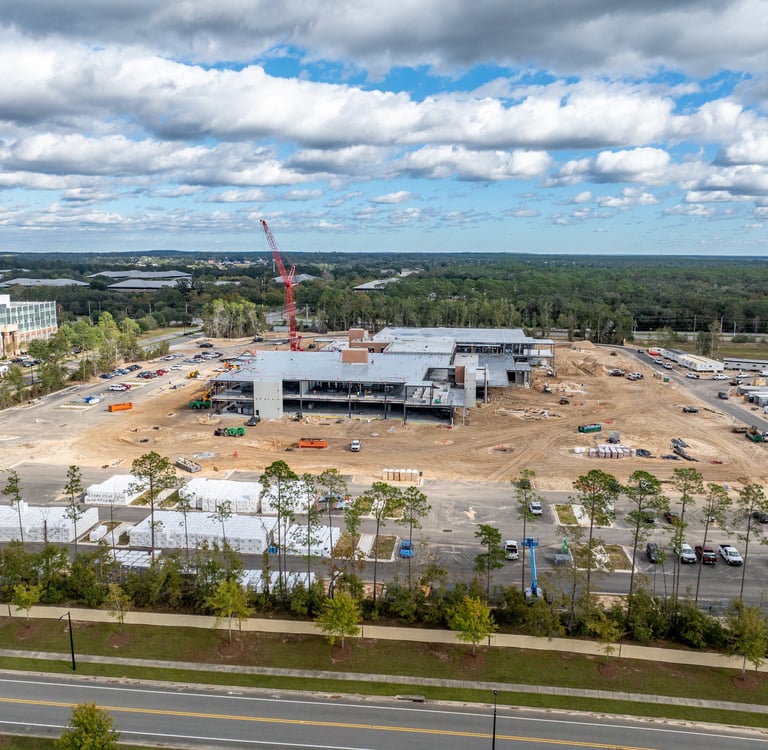 a large building with a crane in the foreground