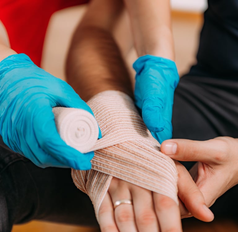 Close up image of a person bandaging someone's hand