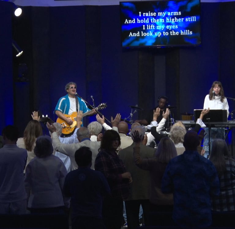 a group of people standing in front of a cross