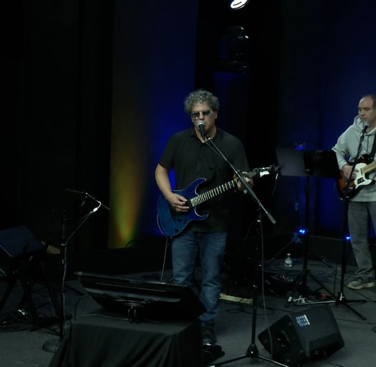 a man playing guitar in a band