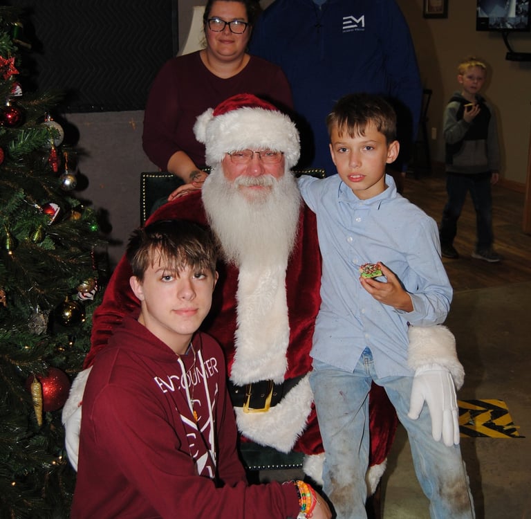 Santa Tom with Family by Christmas Tree