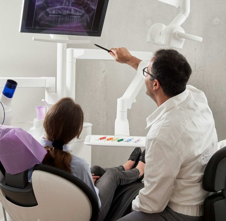 Dentist consulting with a patient in a modern Colorado Springs dental office