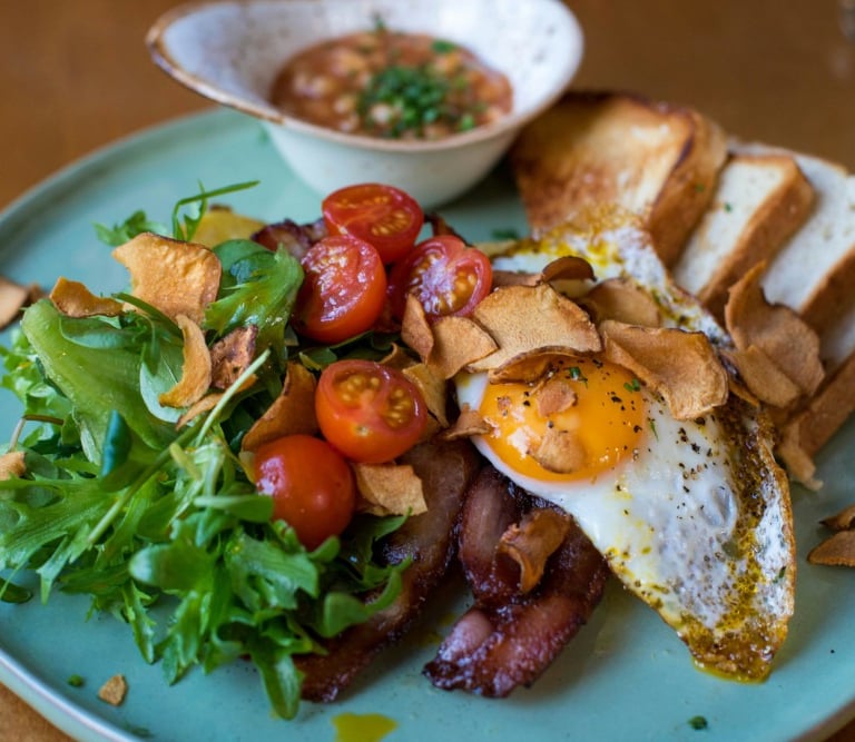 a plate of food with breaded bread and a bowl of soup