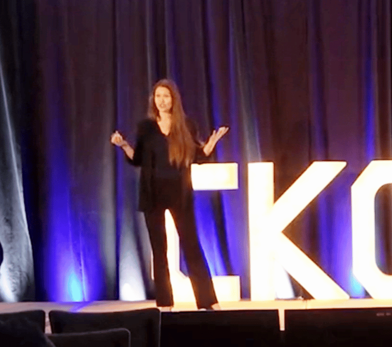 Katie on stage speaking to an audience