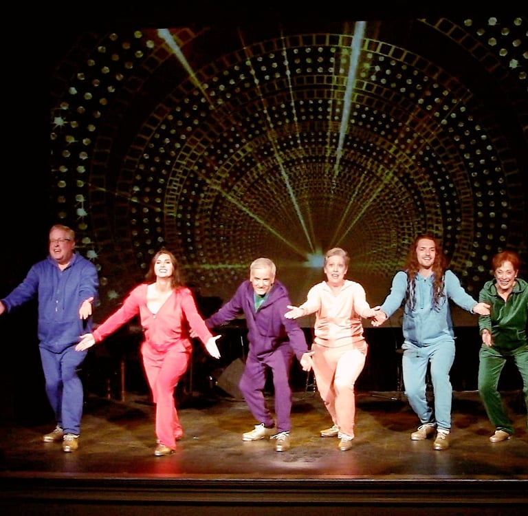A diverse cast of tap dancers in colorful tracksuits performing the final of Alive and Kicking