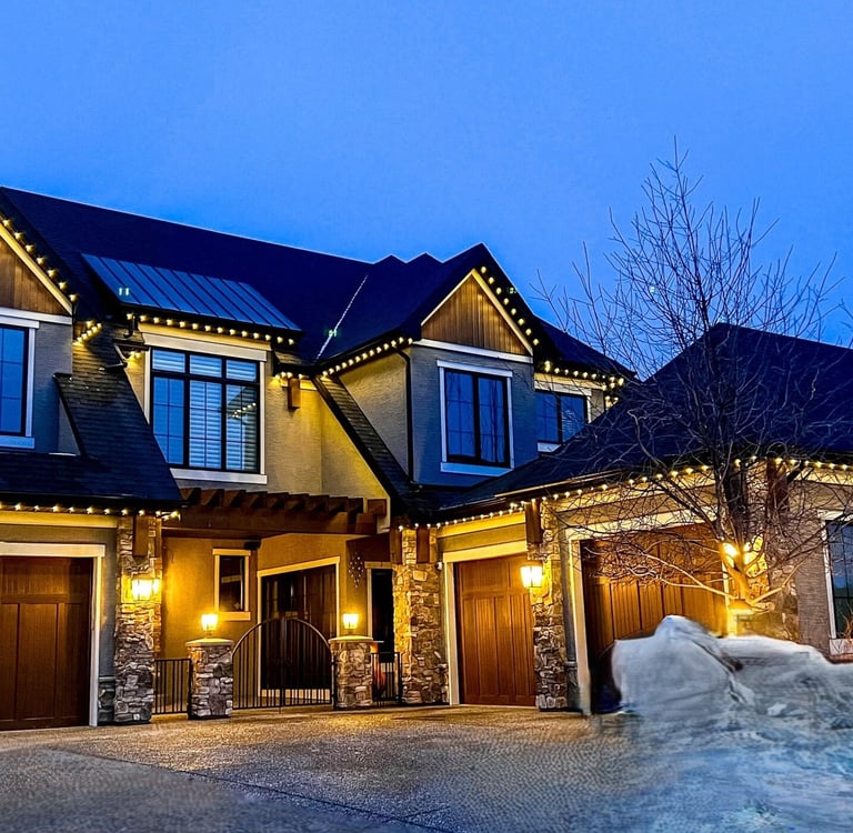 House exterior illuminated with energy -efficient permanent holiday lighting.