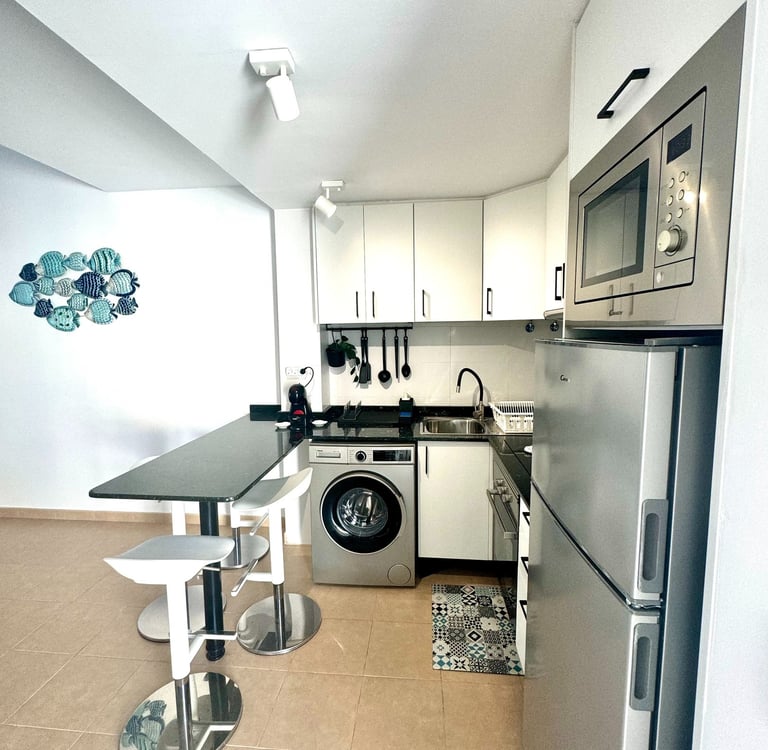 a kitchen with a washing machine and a washing machine