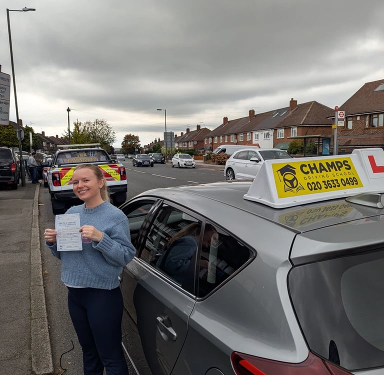 A happy student holding her practical driving test pass certificate next to a Champs Driving School car.
