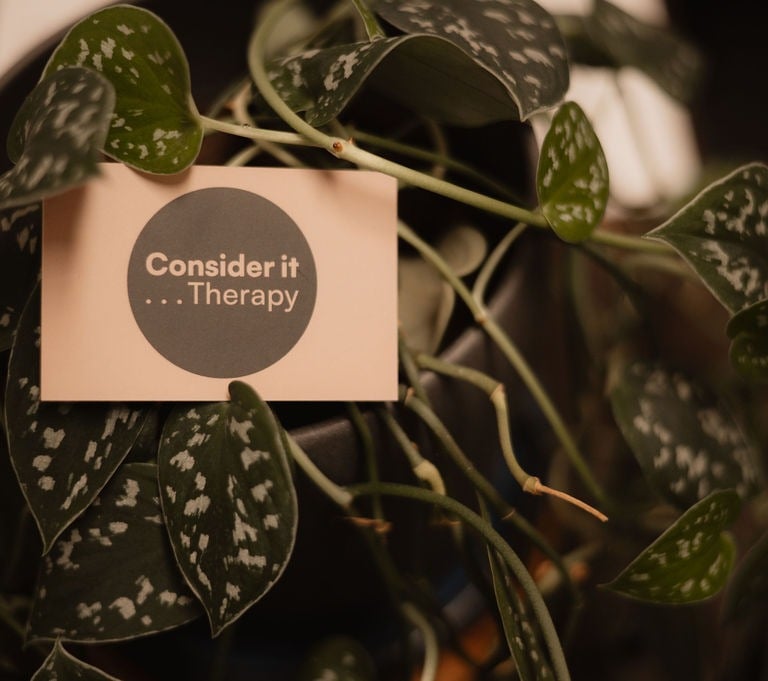 Consider it Therapy business card nestled in green plants — Glasgow therapy practice