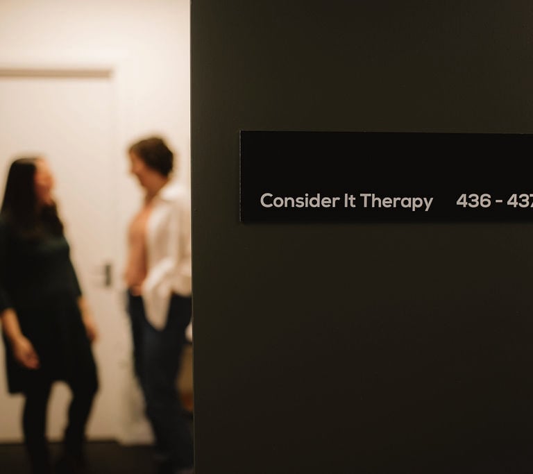 The Consider It Therapy nameplate at Baltic Chambers, with two therapists visible in the background