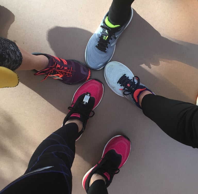 a group of people standing in a circle with their feet on the ground