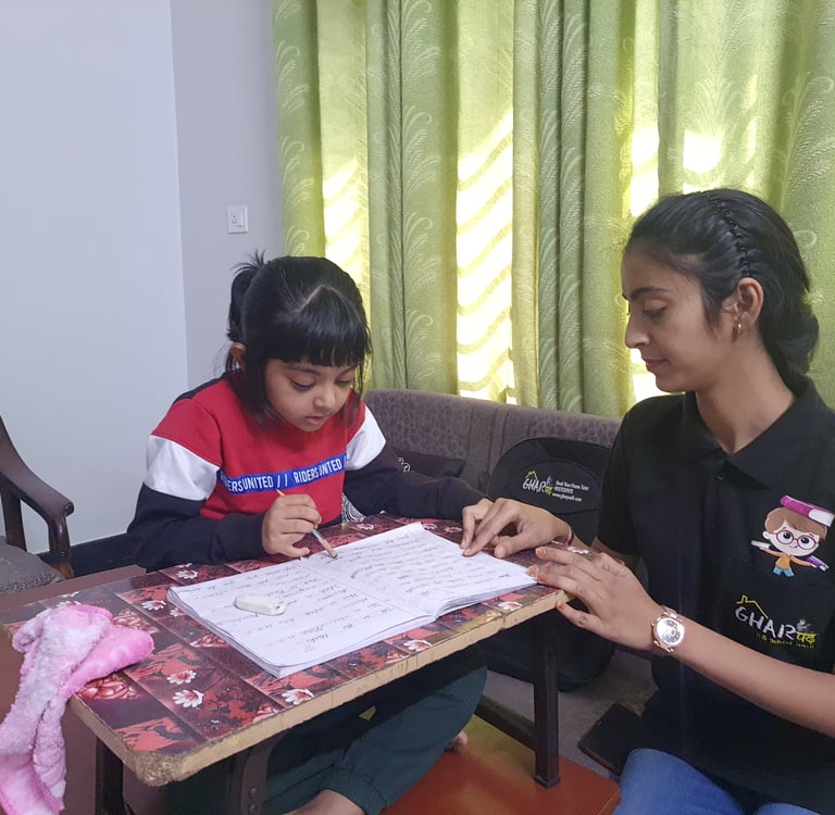 A Gharpadh tutor sitting on a couch with a child teaching