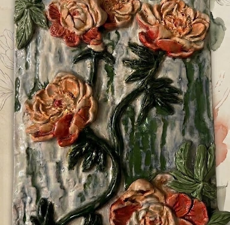 Abstract floral ceramic plaque with hand-built petals and intricate textures.