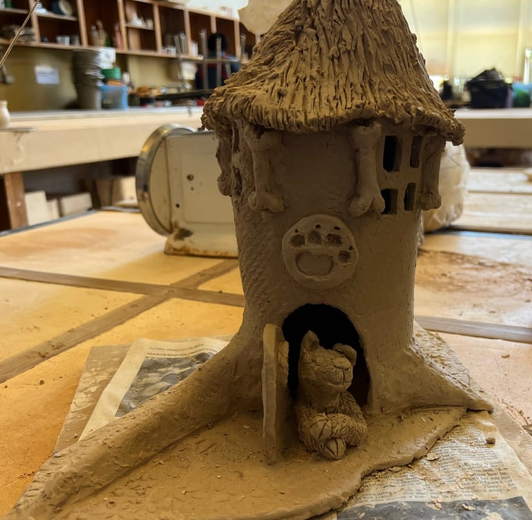 A work-in-progress view of the ceramic base for 'The Barking Spire,' showing the hand-sculpted clay 